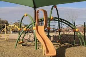 Playground slide and climbing bridge at Citrus Vista Park