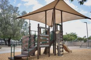 Playground climbing structure and slide at Desert Oasis Park