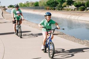 Family Riding Bikes On Paseo Trail