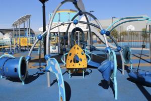 Small playground with tunnels and climbing features at Lantana Ranch Park