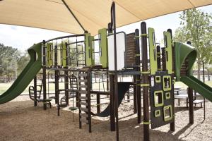 Playground slides and climbing features at Pecos Ranch Park
