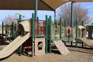 Playground climbing wall, slides, and bridge at Pinelake Park