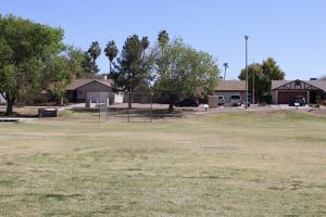 Open Grass Field At Sunset Park