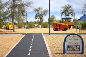 City Land Playground With Interactive Buses And Play Structure At Tumbleweed Park