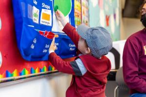 Young boy in interacting in building blocks classroom