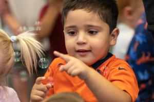 young child playing at building blocks program