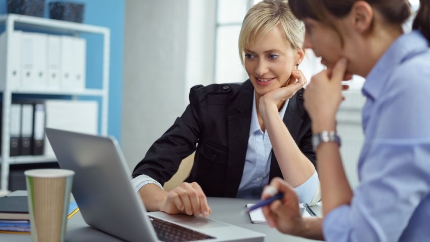 Woman helping client with taxes