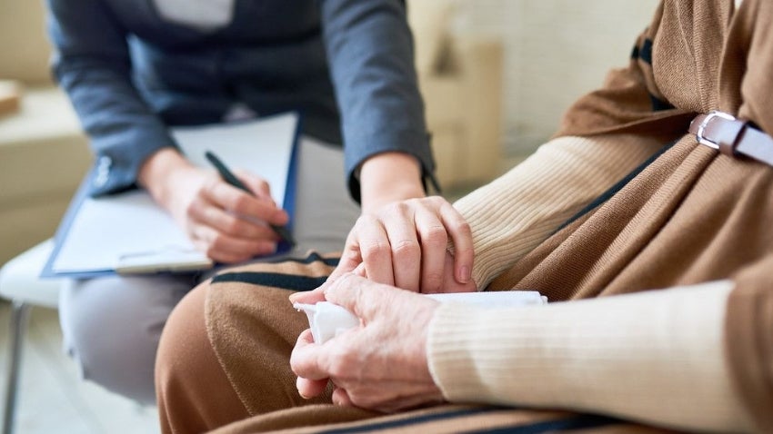 Woman comforting another during an intake process