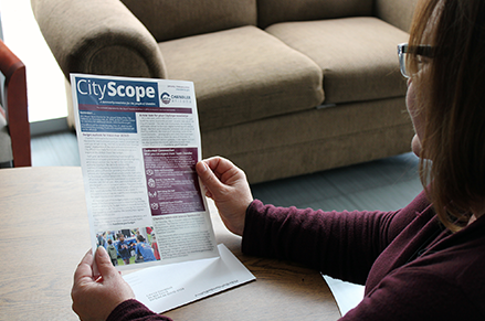 Woman reading the new CityScope Newsletter